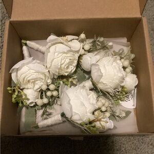 Four pack white boutonnières